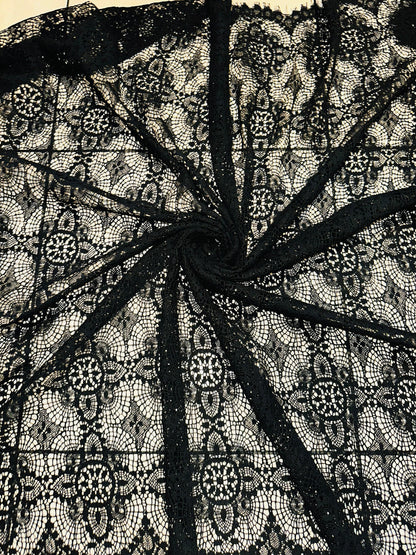 French chantilly lace, Black 36” wide, allover rose abstract design, 2 scallop edges with eyelash fringe. This is an elegant-looking lace.