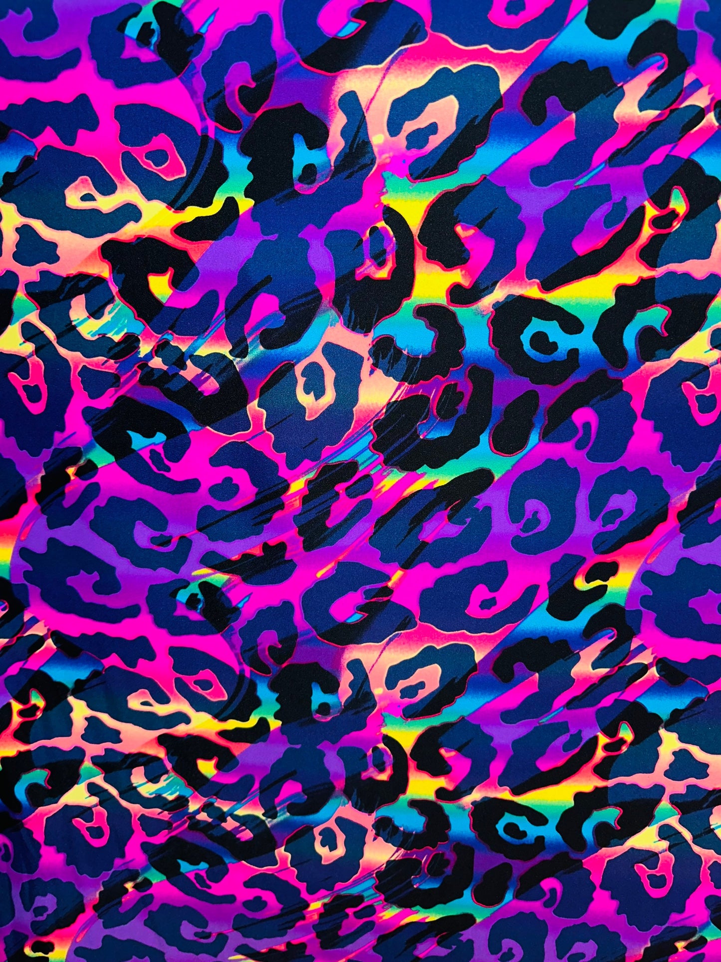 Wildcat  design multicolor print on best quality of nylon spandex 4-way stretch UV light it glows under black light 58/60” Sold by the YD.