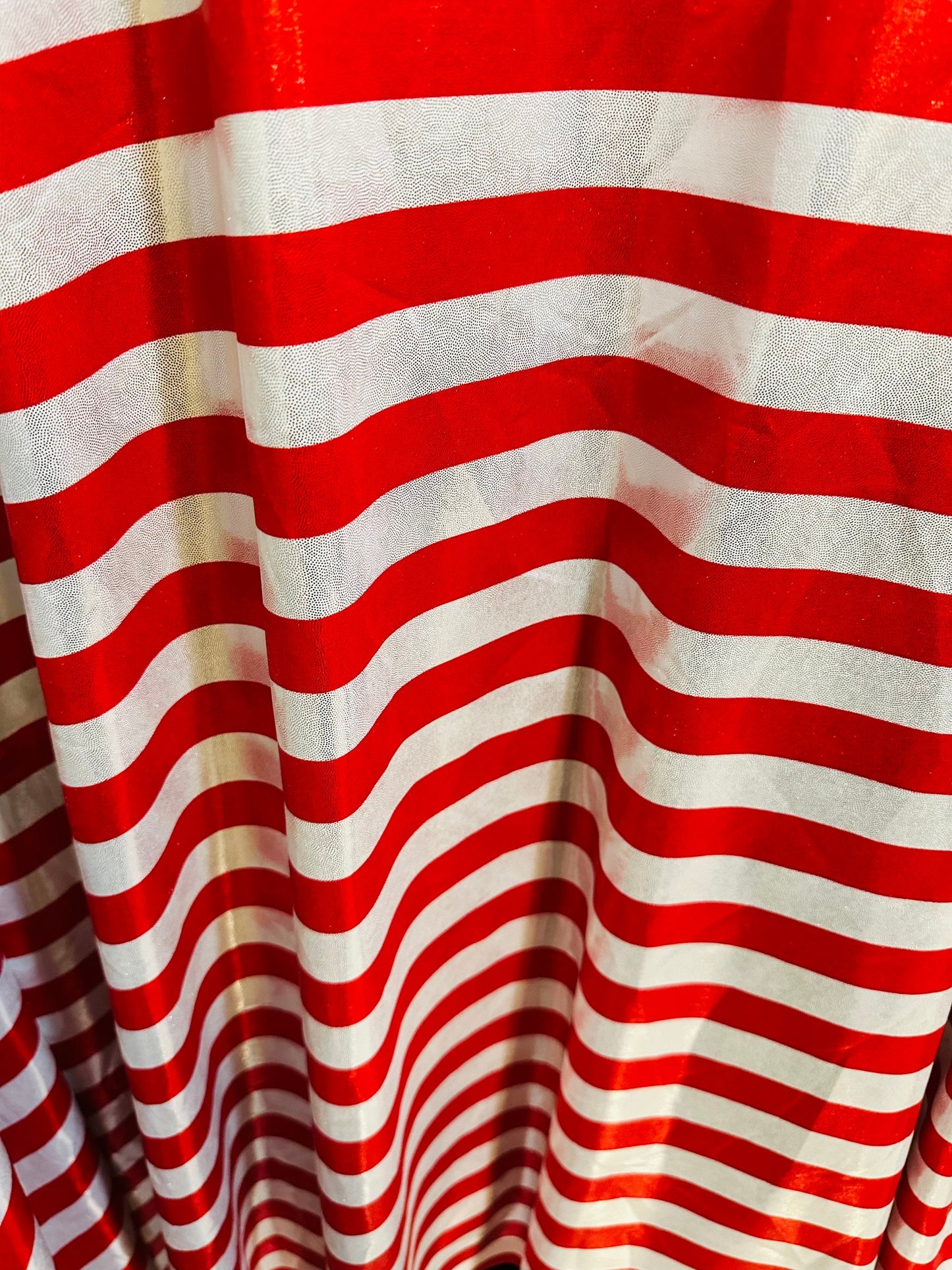 Freedom stripes design red/silver print on metallic nylon spandex with foggy foil 4-way stretch 58/60” Sold by the YD.