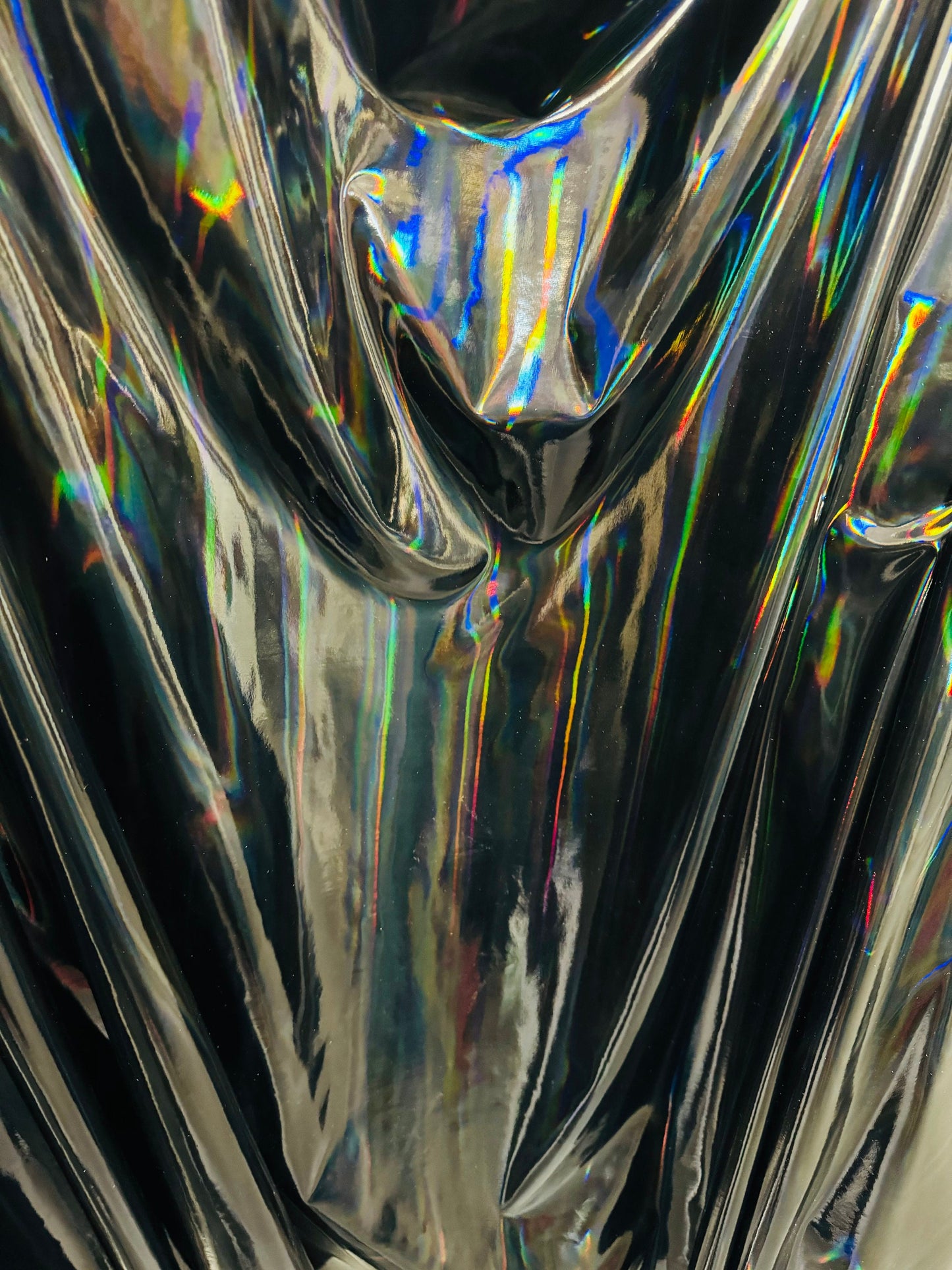 New lacer iridescent black vinyl 4-way stretch 58/60” Sold by the YD. Ships worldwide from Los Angeles California USA