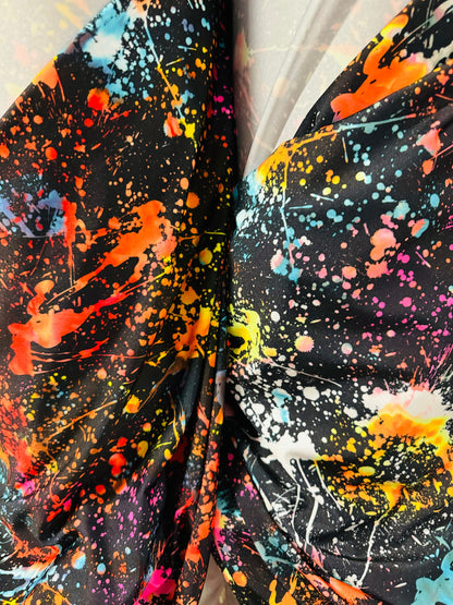 Luxury splatter paint design Black/Multicolor print on nylon spandex 4-way stretch 58/60” Sold by the YD. Ships worldwide