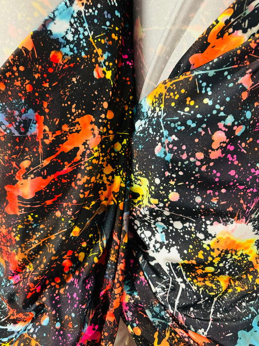 Luxury splatter paint design Black/Multicolor print on nylon spandex 4-way stretch 58/60” Sold by the YD. Ships worldwide