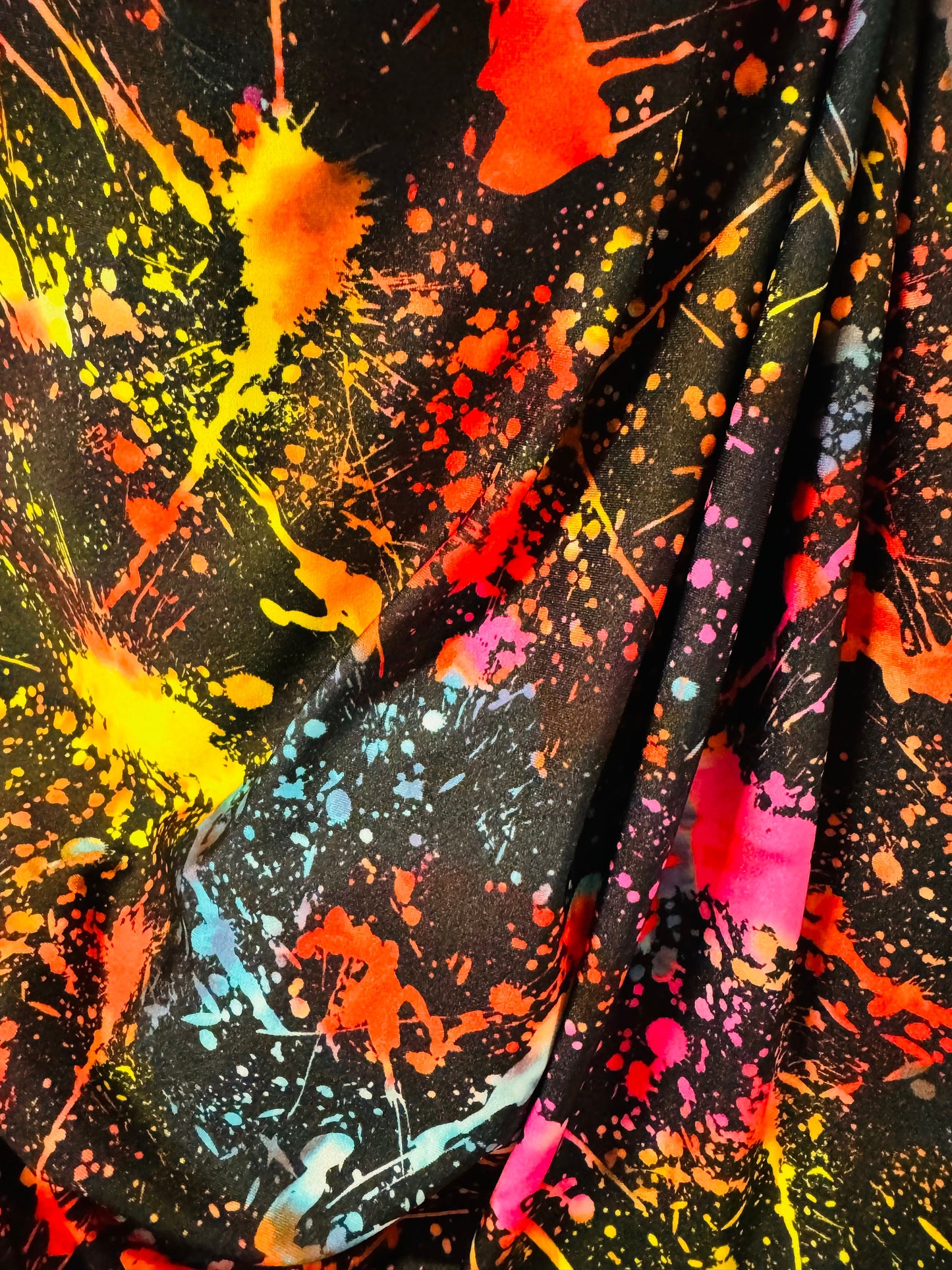 Luxury splatter paint design Black/Multicolor print on nylon spandex 4-way stretch 58/60” Sold by the YD. Ships worldwide