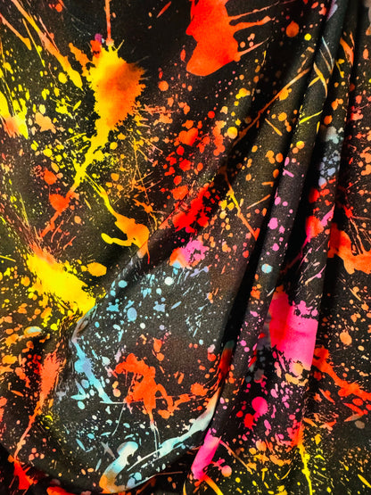 Luxury splatter paint design Black/Multicolor print on nylon spandex 4-way stretch 58/60” Sold by the YD. Ships worldwide