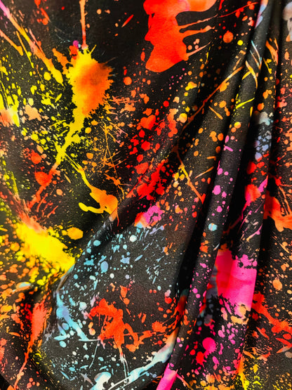 Luxury splatter paint design Black/Multicolor print on nylon spandex 4-way stretch 58/60” Sold by the YD. Ships worldwide