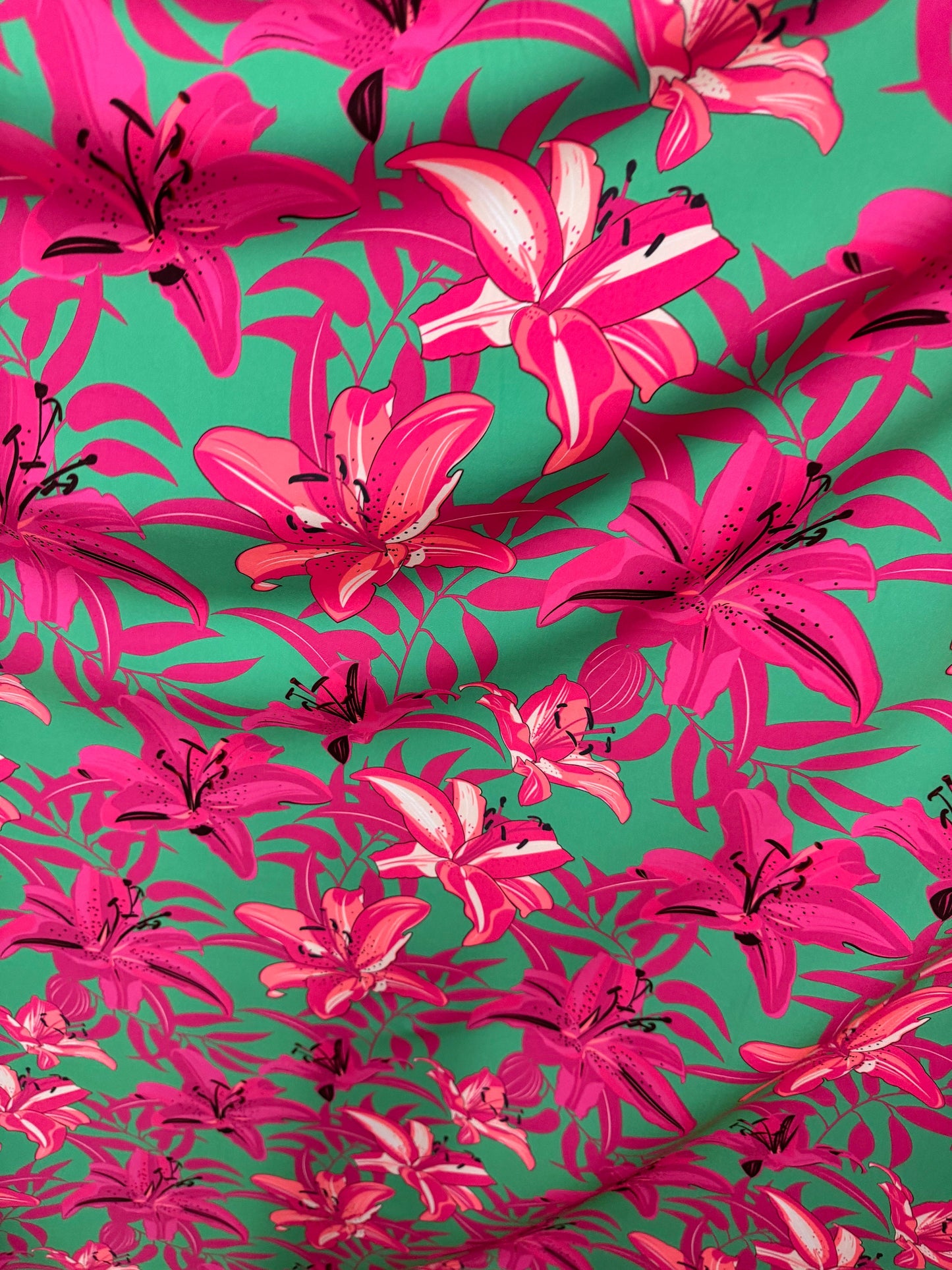 New flower design pink/green print on great quality of poly spandex 4-way stretch 58/60” Sold by the YD.