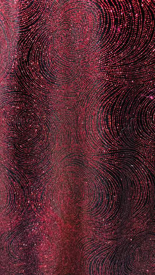 Swirl design on stretch velvet with glitter black/red 4-way stretch 58/60”