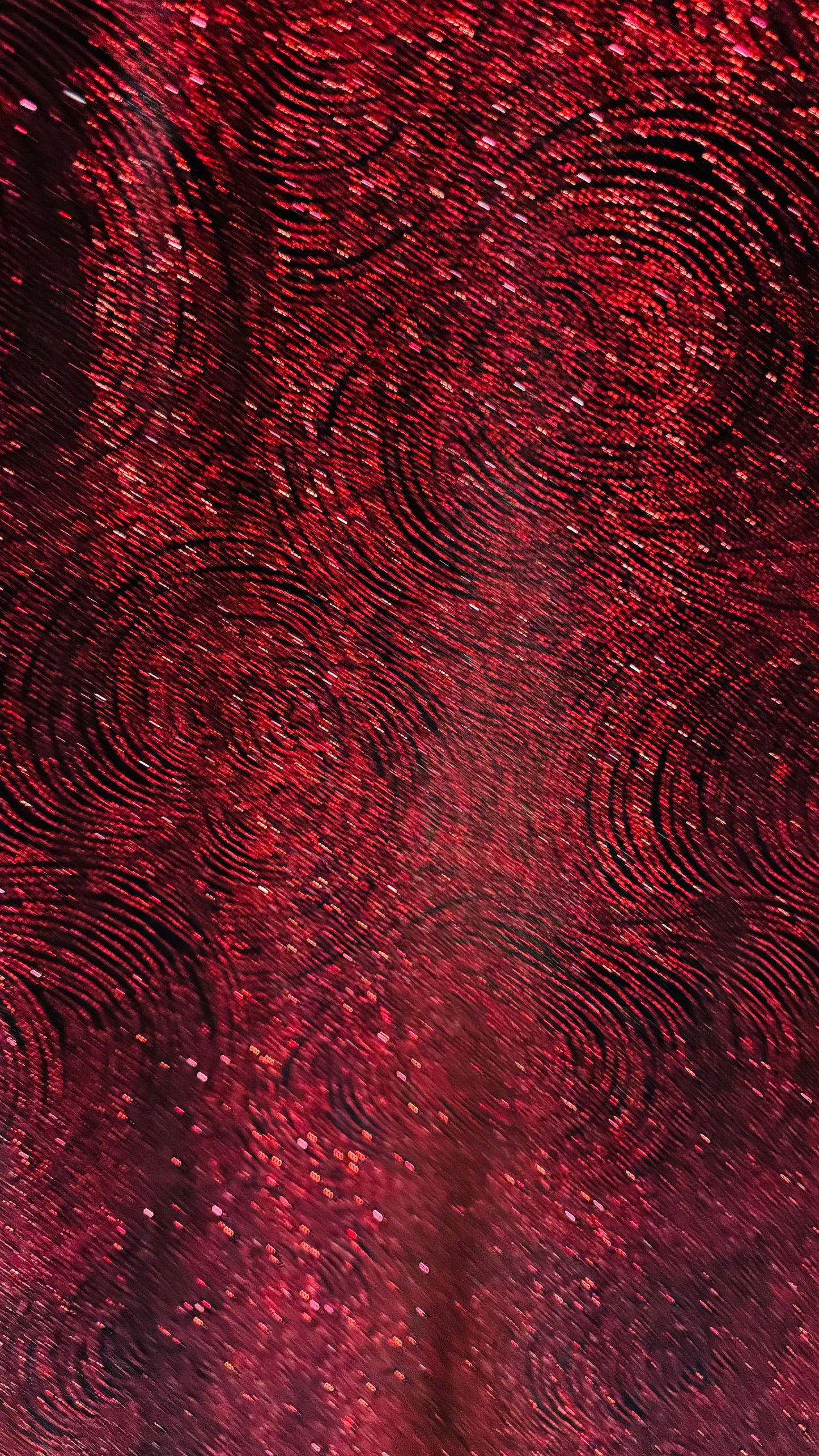 Swirl design on stretch velvet with glitter black/red 4-way stretch 58/60”