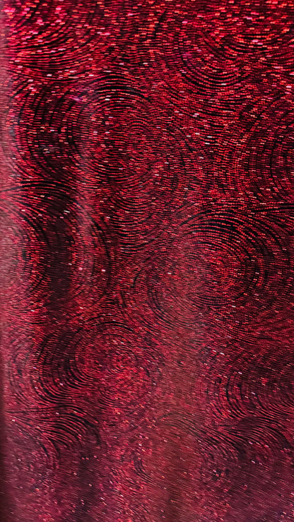 Swirl design on stretch velvet with glitter black/red 4-way stretch 58/60”
