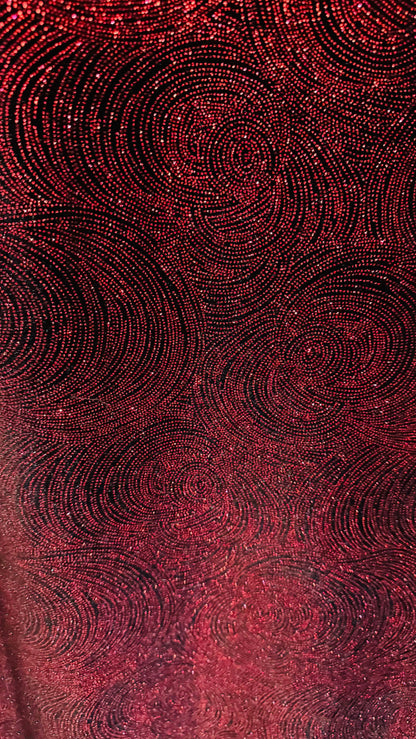 Swirl design on stretch velvet with glitter black/red 4-way stretch 58/60”