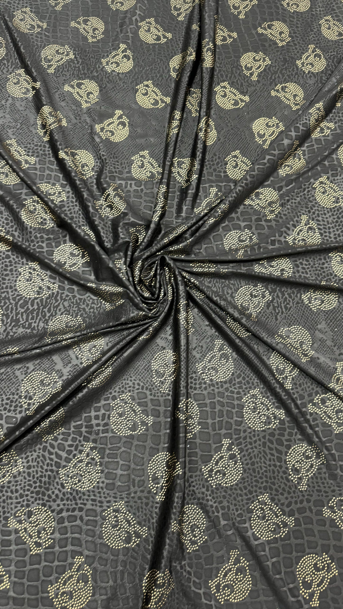 New skull design on embossed metallic poly spandex 2-way stretch 58/60” Sold by the YD. Ships worldwide from Los Angeles California USA