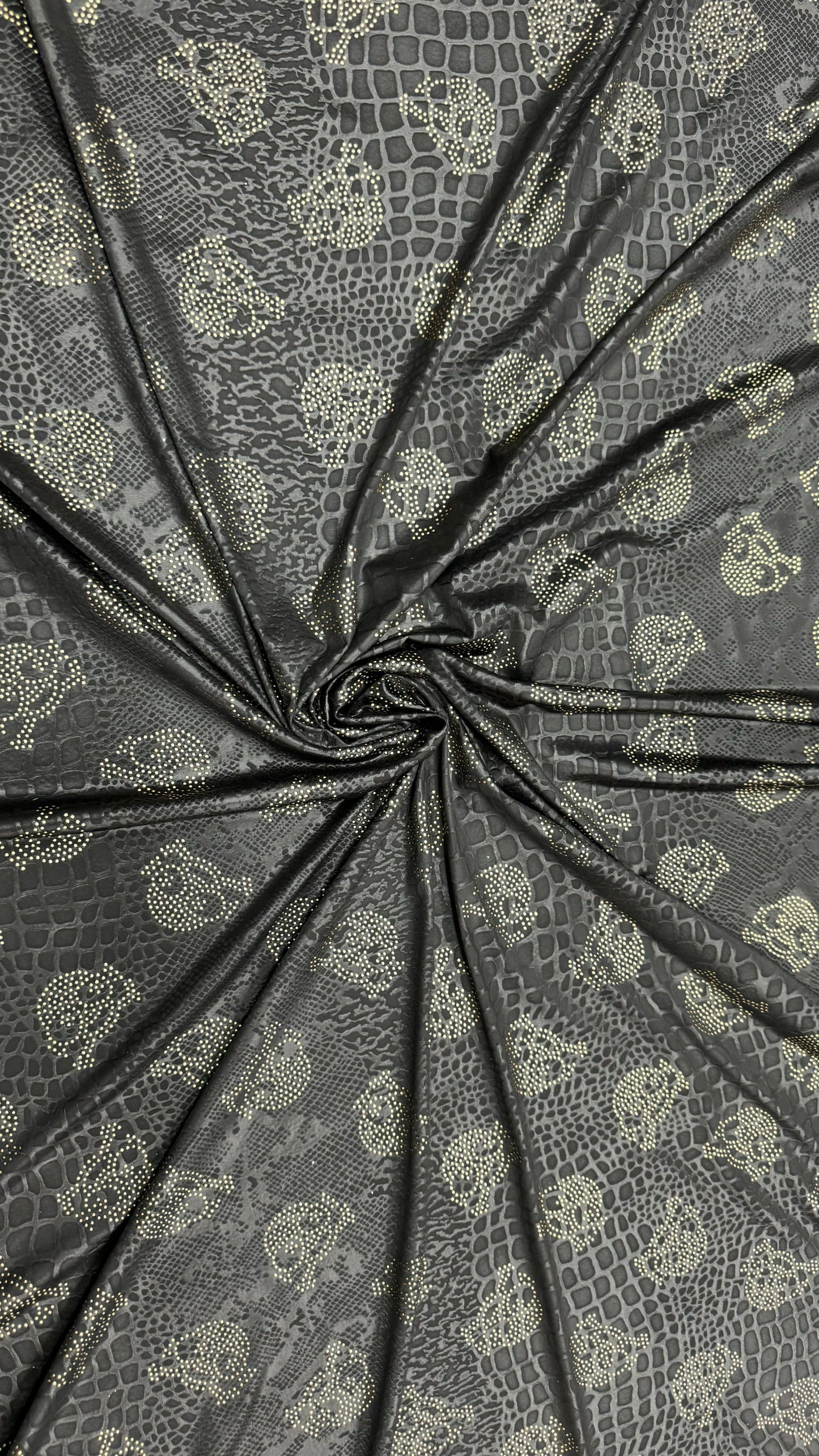 New skull design on embossed metallic poly spandex 2-way stretch 58/60” Sold by the YD. Ships worldwide from Los Angeles California USA