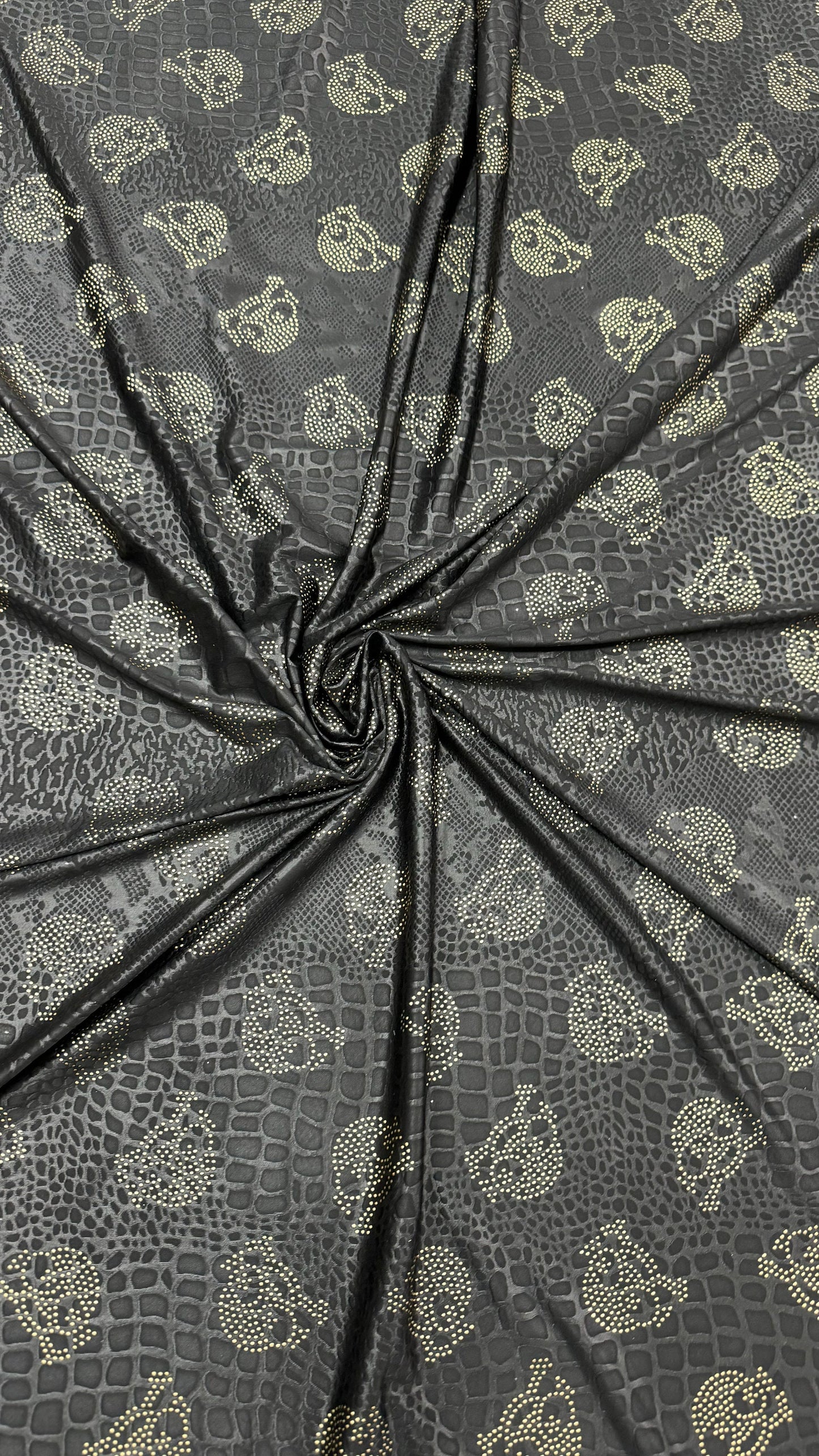 New skull design on embossed metallic poly spandex 2-way stretch 58/60” Sold by the YD. Ships worldwide from Los Angeles California USA