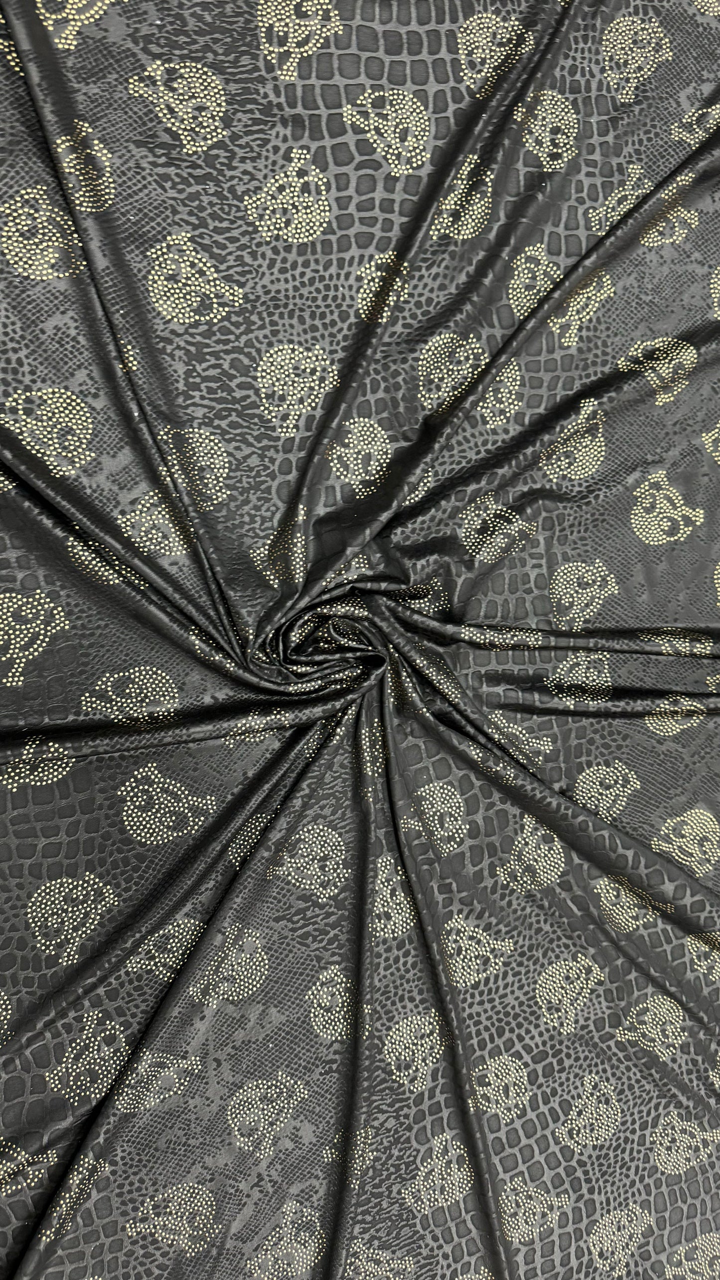 New skull design on embossed metallic poly spandex 2-way stretch 58/60” Sold by the YD. Ships worldwide from Los Angeles California USA