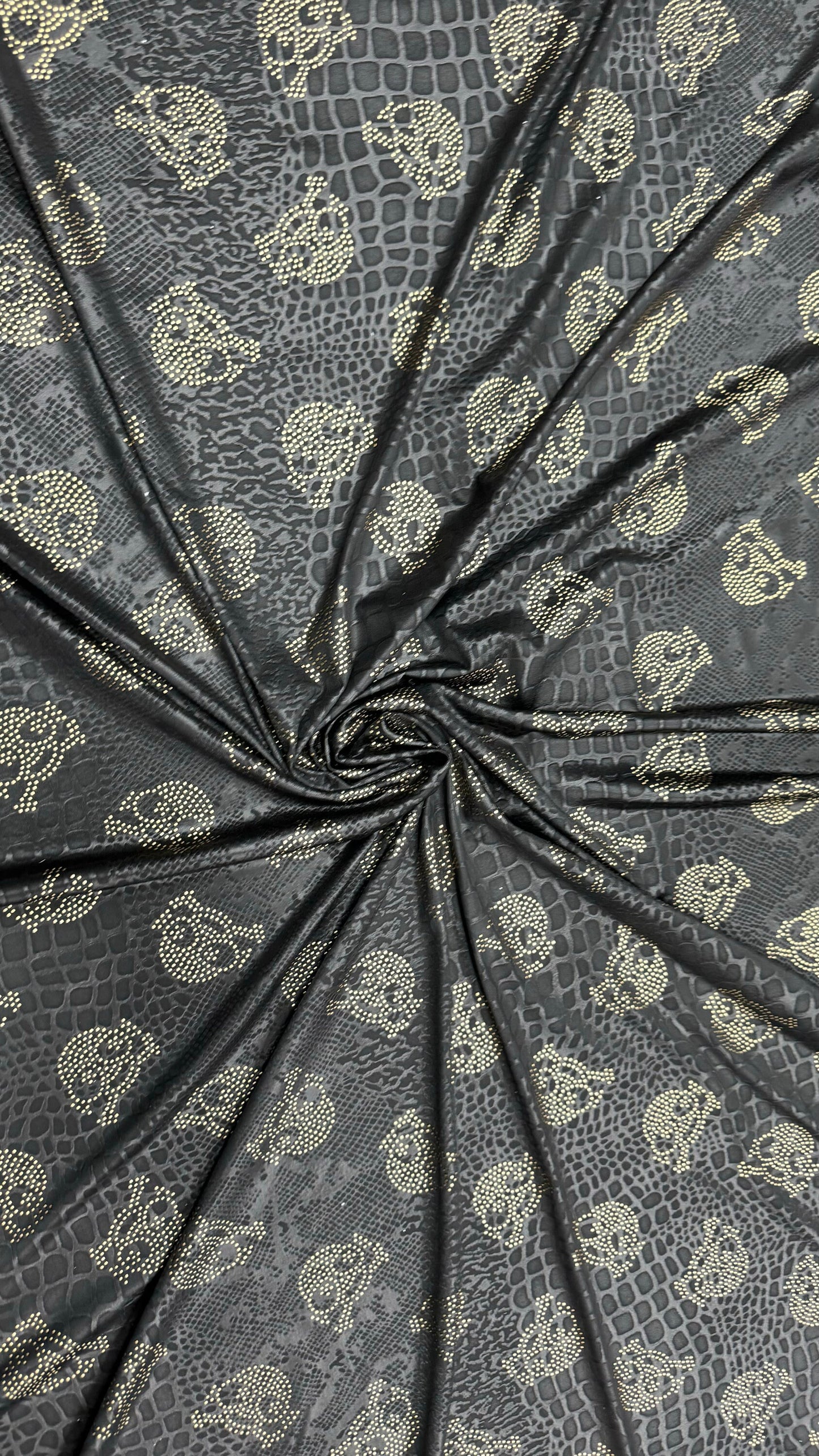 New skull design on embossed metallic poly spandex 2-way stretch 58/60” Sold by the YD. Ships worldwide from Los Angeles California USA