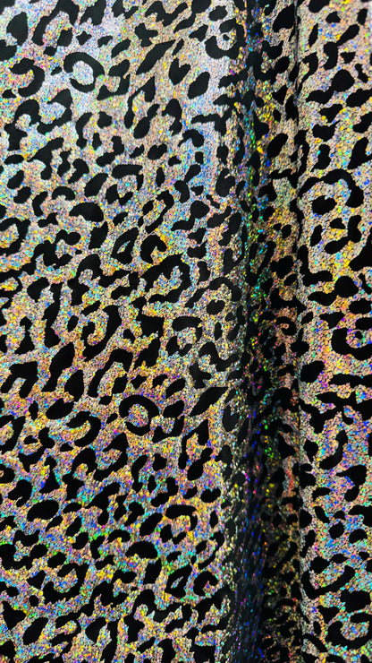 Hologram exotic leopard design metallic poly  spandex 2-way stretch 58/60” Sold by the YD. Ships worldwide from Los Angeles California USA.