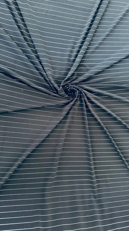 Pin stripes on Poly spandex 4-way stretch 58/60” Sold by the YD. Ships worldwide from Los Angeles California USA. High quality fabrics