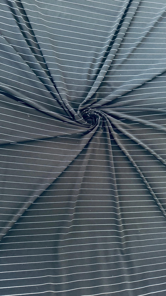 Pin stripes on Poly spandex 4-way stretch 58/60” Sold by the YD. Ships worldwide from Los Angeles California USA. High quality fabrics