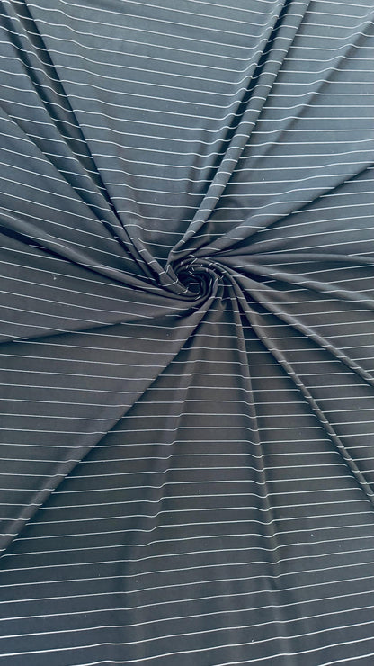 Pin stripes on Poly spandex 4-way stretch 58/60” Sold by the YD. Ships worldwide from Los Angeles California USA. High quality fabrics