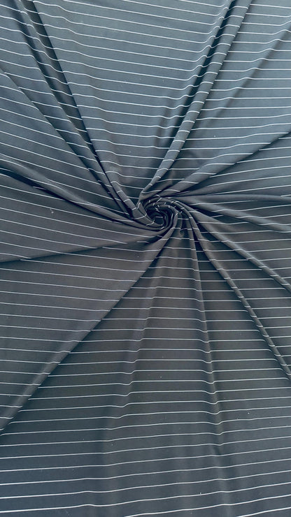 Pin stripes on Poly spandex 4-way stretch 58/60” Sold by the YD. Ships worldwide from Los Angeles California USA. High quality fabrics