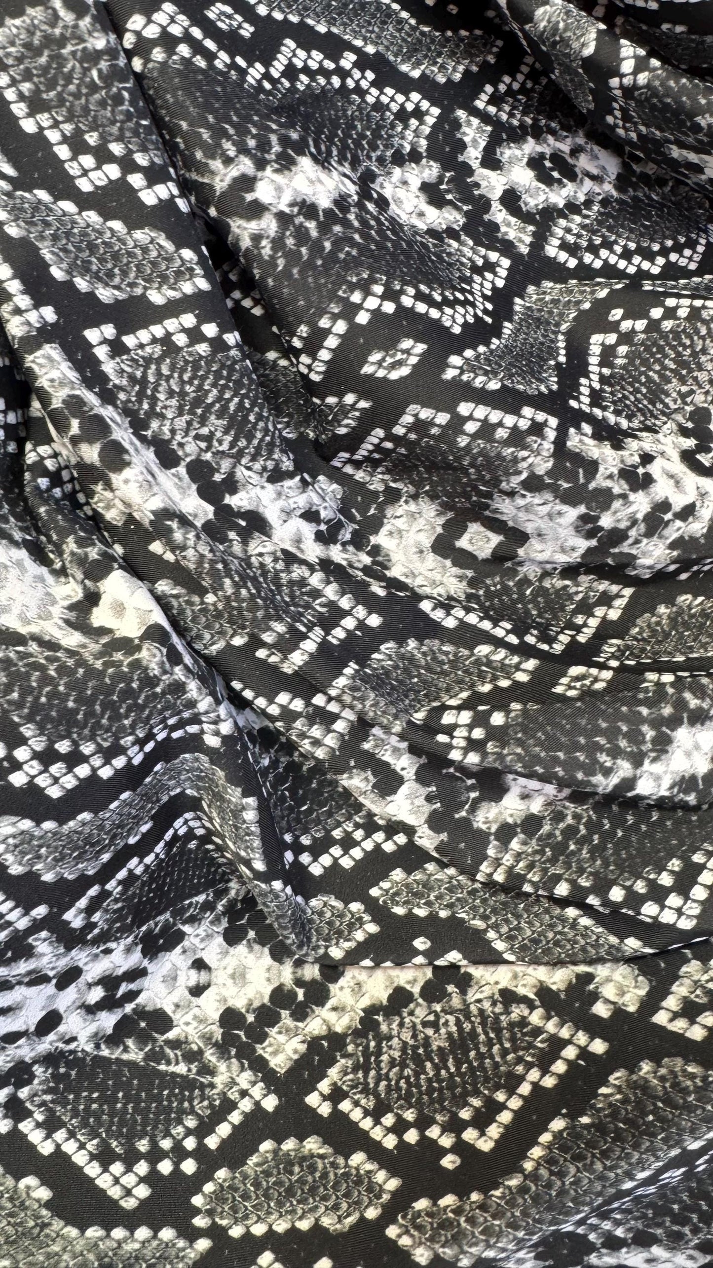 New snake print white/black  print on nylon spandex 4way stretch 58/60" Sold by the YD. Ships worldwide from Los Angeles California USA.