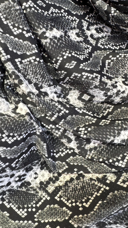 New snake print white/black  print on nylon spandex 4way stretch 58/60" Sold by the YD. Ships worldwide from Los Angeles California USA.