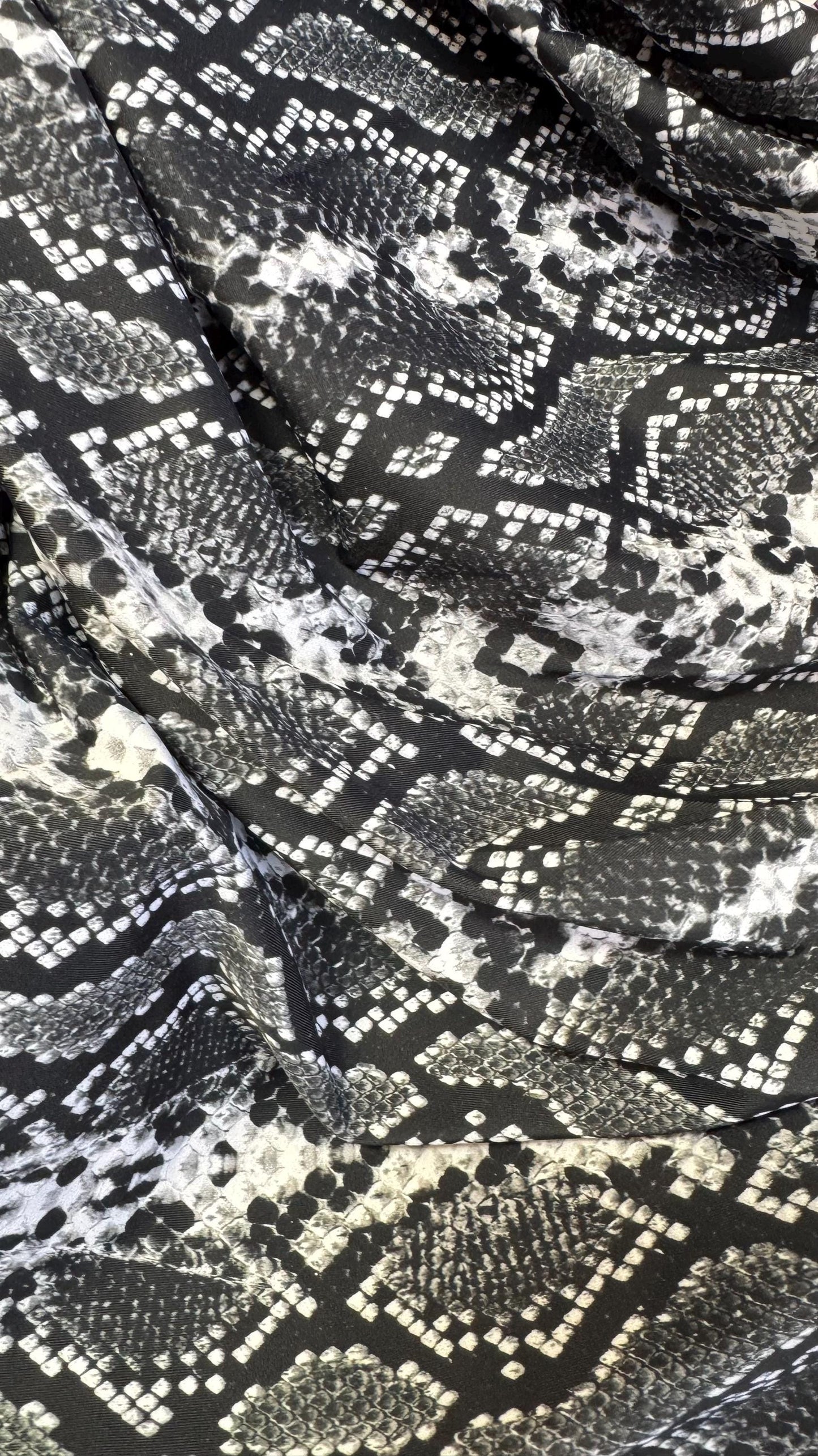 New snake print white/black  print on nylon spandex 4way stretch 58/60" Sold by the YD. Ships worldwide from Los Angeles California USA.