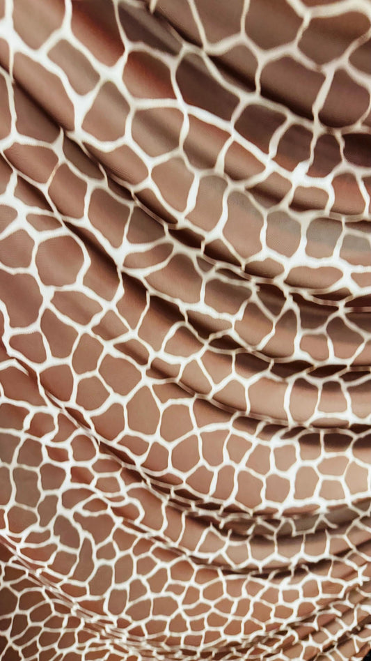 Giraffe design print on power mesh 4-way stretch 58/60” Sold by the YD. Ships Worldwide from Los Angeles California USA.
