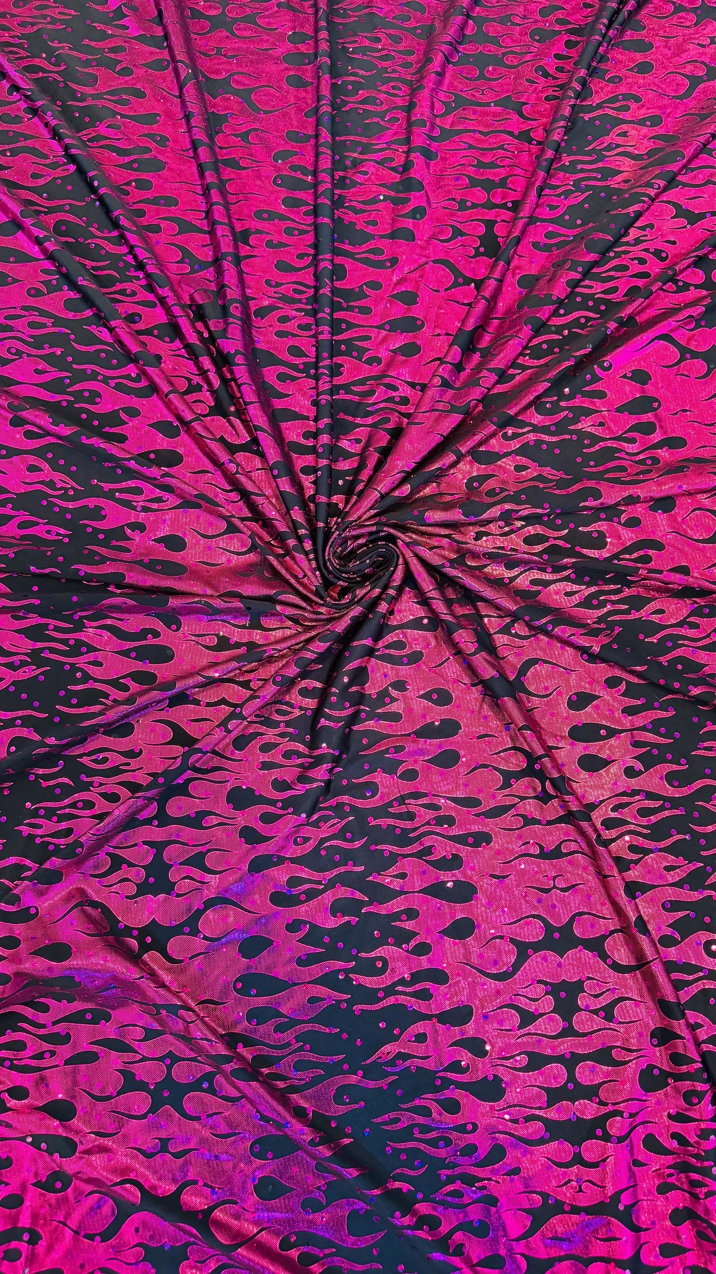 New hologram flames design metallic poly spandex black/Fuchsia 2-way stretch 58/60” Sold by the YD. Ships worldwide from Los Angeles CA USA.