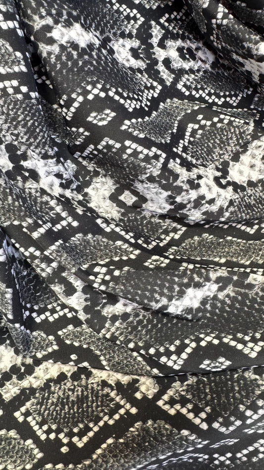 New snake print white/black  print on nylon spandex 4way stretch 58/60" Sold by the YD. Ships worldwide from Los Angeles California USA.