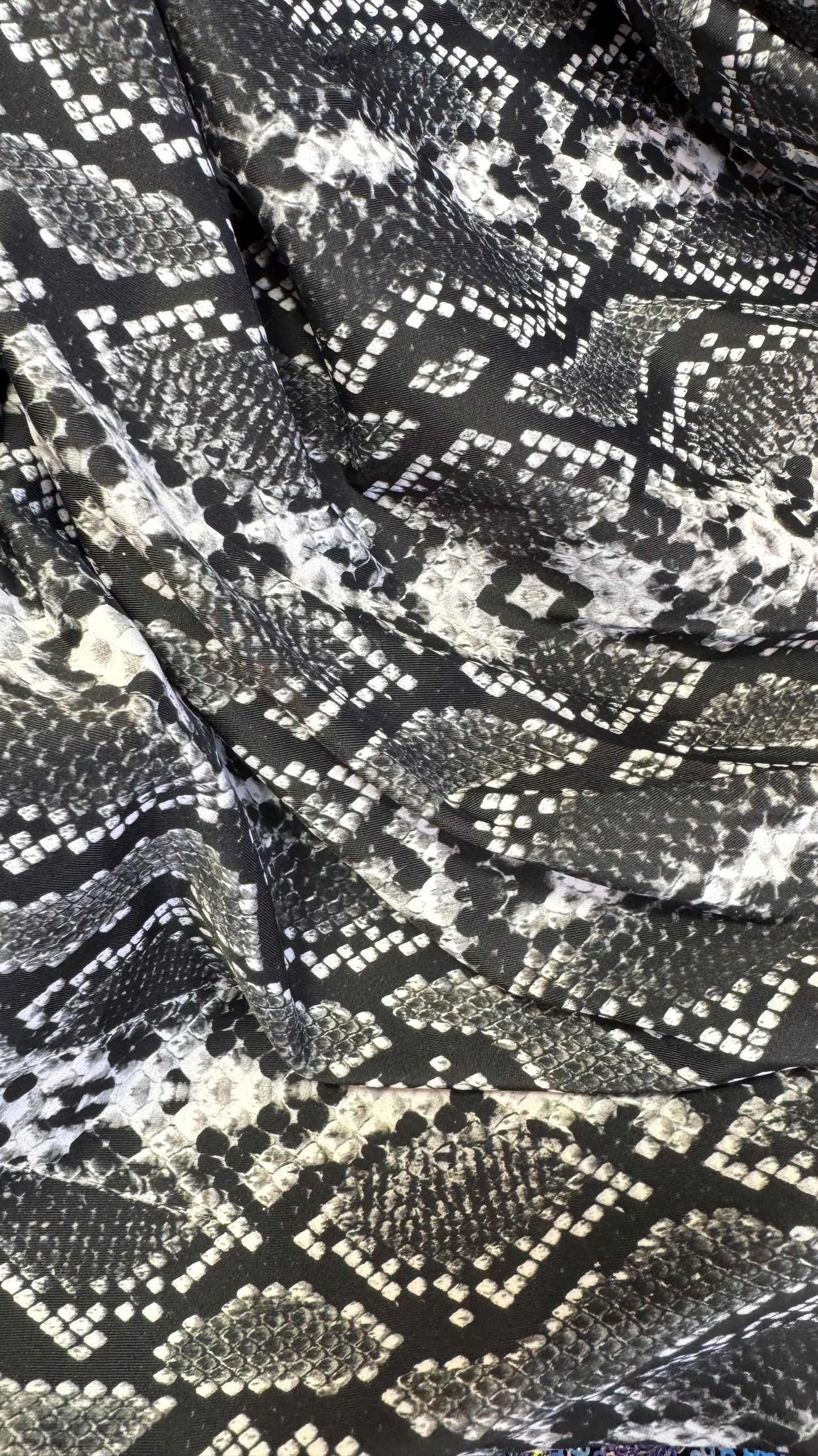 New snake print white/black  print on nylon spandex 4way stretch 58/60" Sold by the YD. Ships worldwide from Los Angeles California USA.