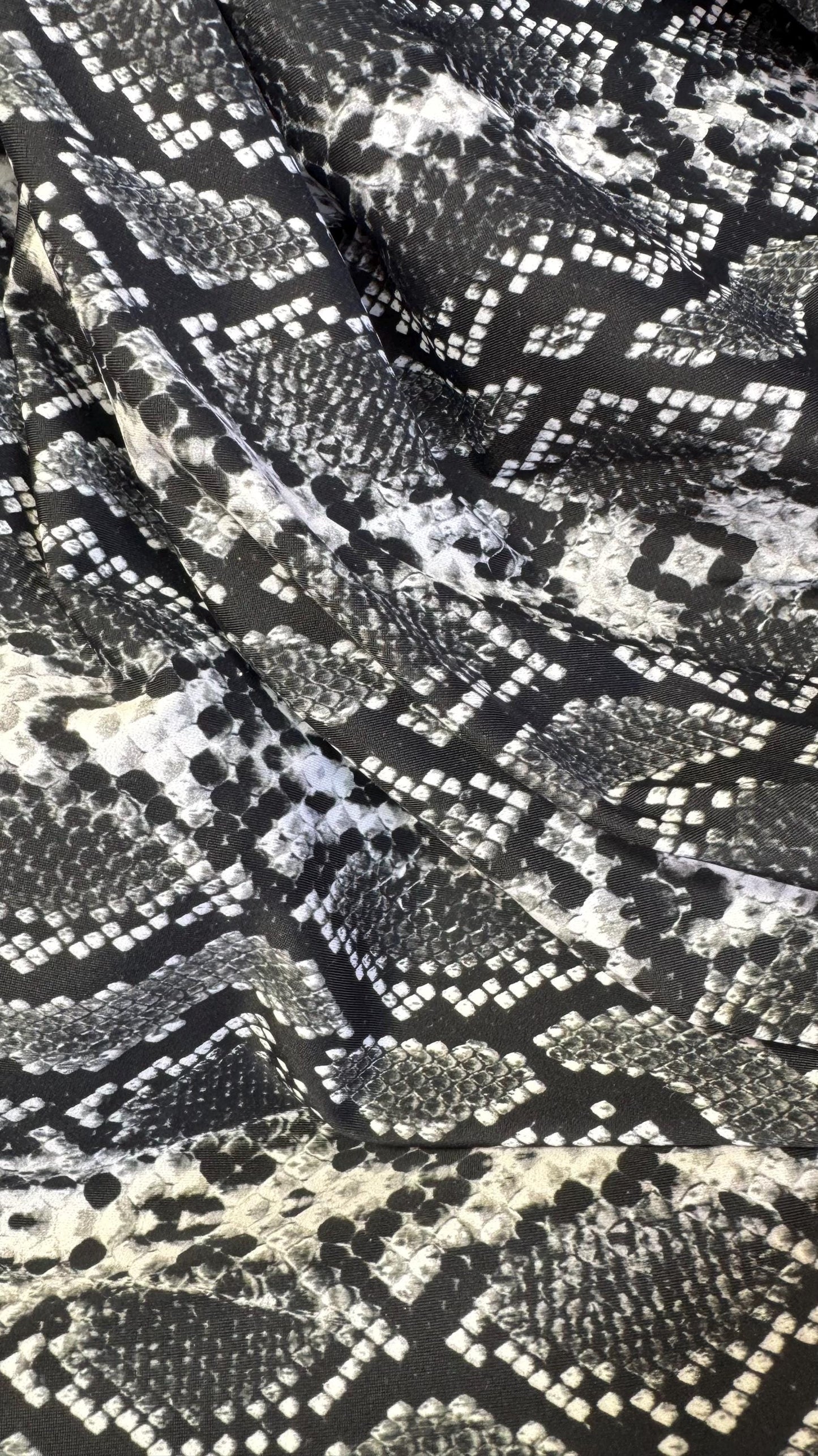 New snake print white/black  print on nylon spandex 4way stretch 58/60" Sold by the YD. Ships worldwide from Los Angeles California USA.