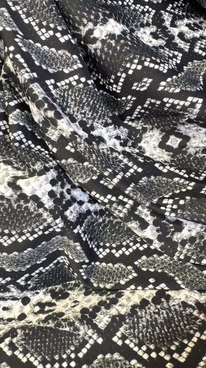 New snake print white/black  print on nylon spandex 4way stretch 58/60" Sold by the YD. Ships worldwide from Los Angeles California USA.