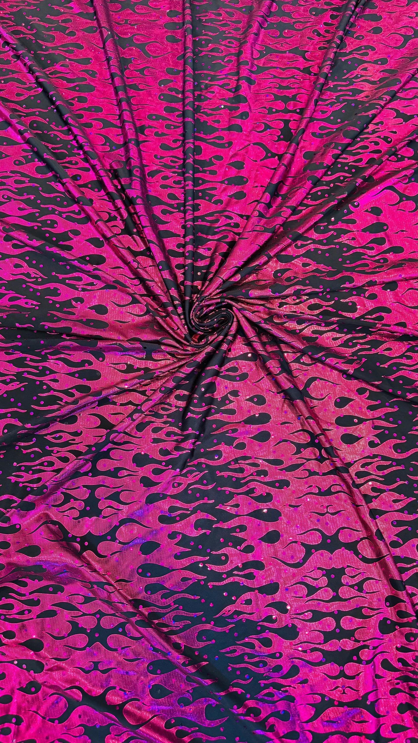 New hologram flames design metallic poly spandex black/Fuchsia 2-way stretch 58/60” Sold by the YD. Ships worldwide from Los Angeles CA USA.