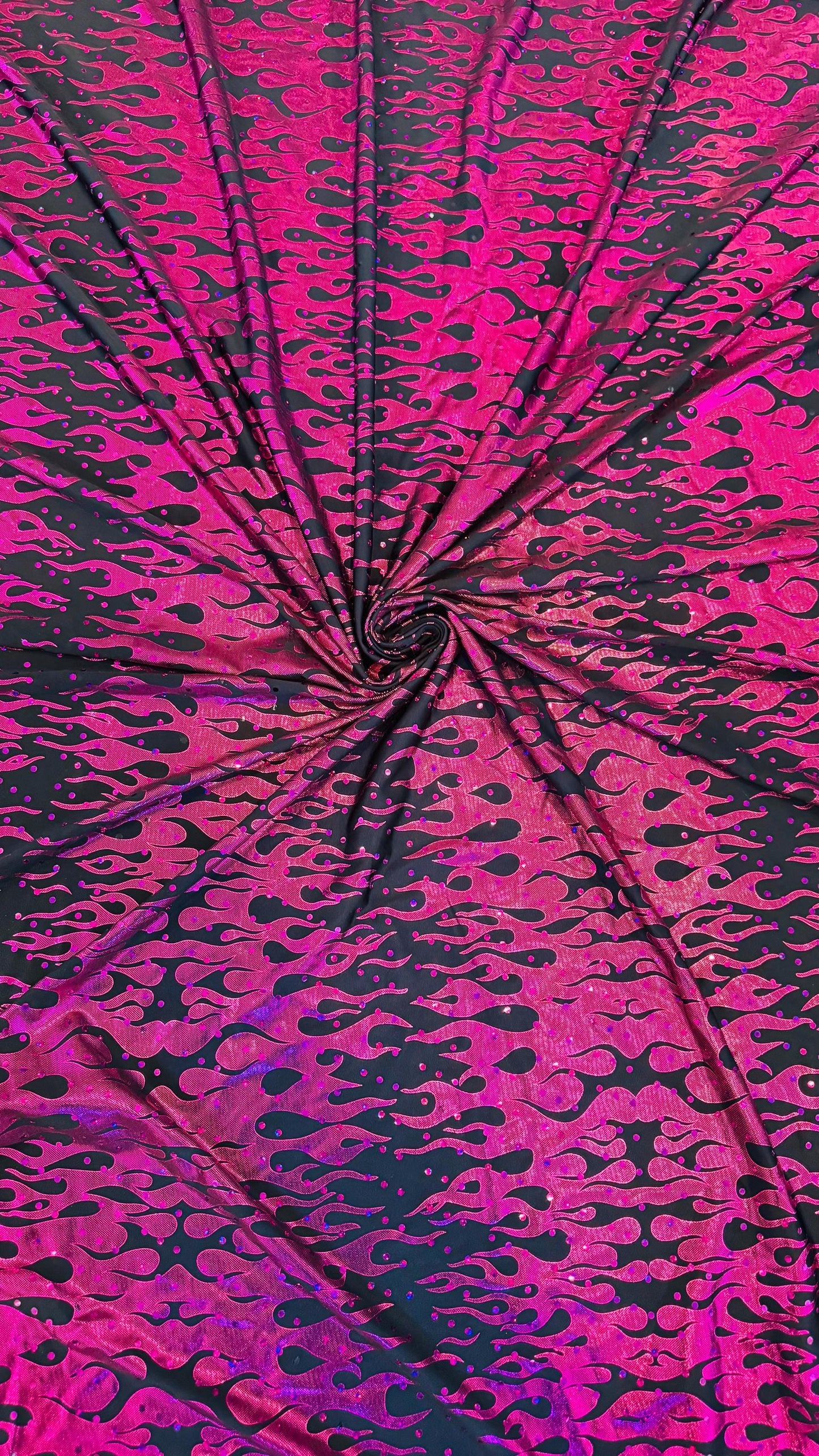 New hologram flames design metallic poly spandex black/Fuchsia 2-way stretch 58/60” Sold by the YD. Ships worldwide from Los Angeles CA USA.