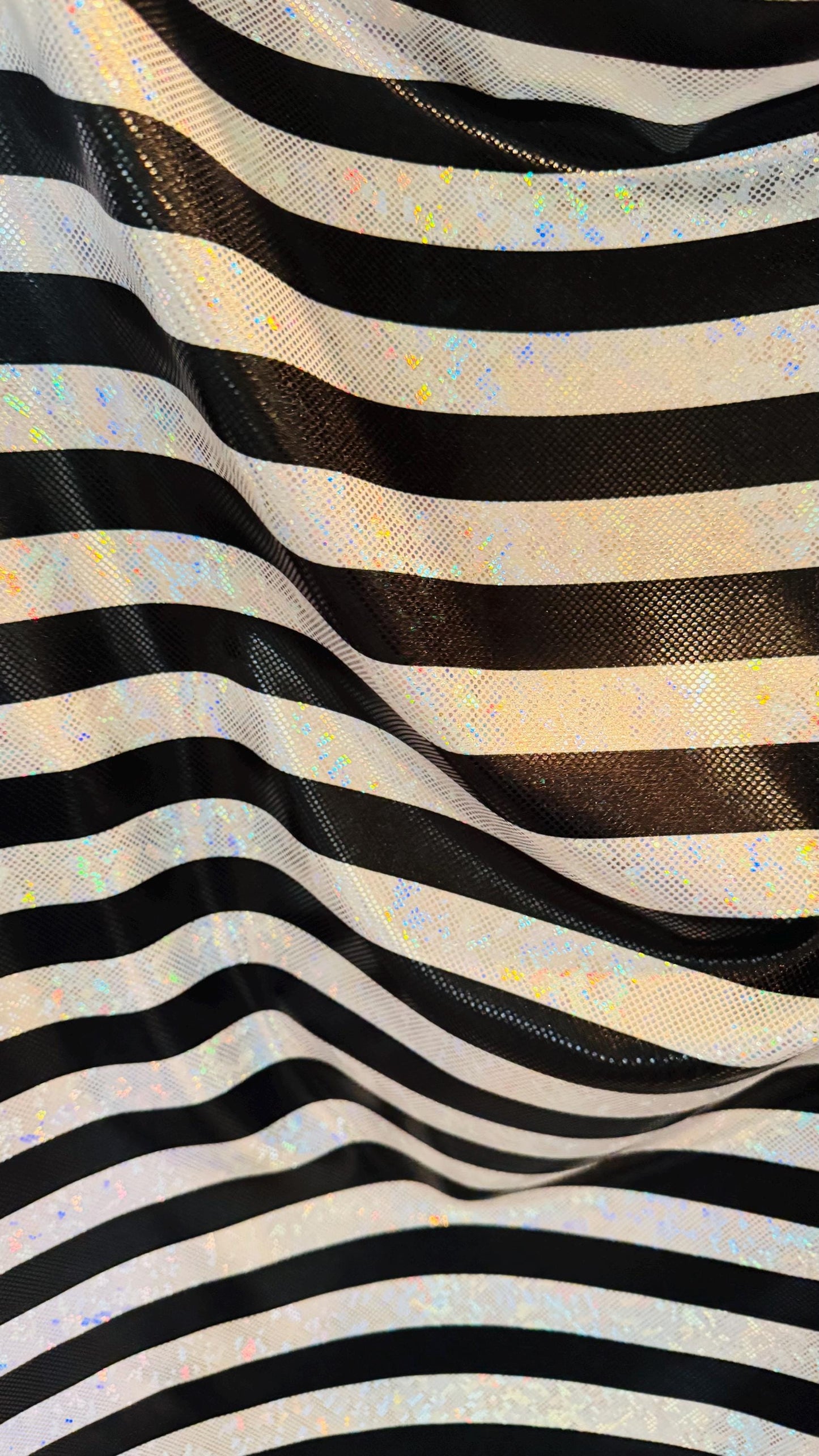 Stripes Freedom design 1” on metallic shattered glass hologram nylon spandex 4-way stretch 58/60” Multicolor Sold by the YD.