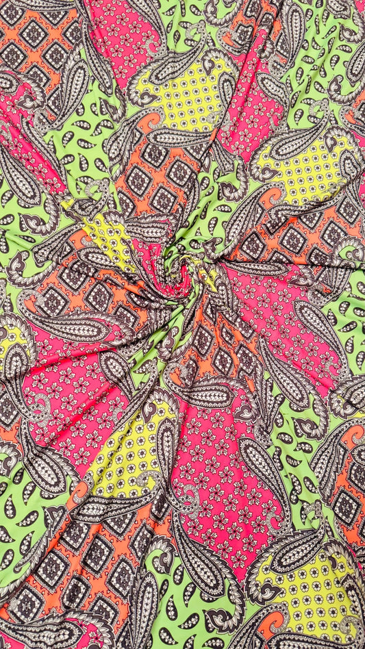 New paisley design Neon colors multicolor print on poly spandex jersey 4-way stretch 58/60” Sold by the YD.  High quality fabrics