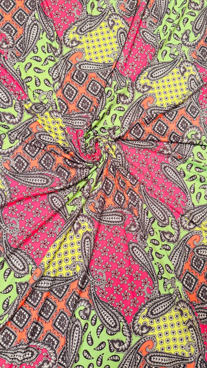 New paisley design Neon colors multicolor print on poly spandex jersey 4-way stretch 58/60” Sold by the YD.  High quality fabrics