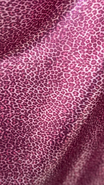 Wild Cheetah pink design Small size on foggy foil metallic nylon spandex 4-way stretch 58/60” Sold by the YD. Ships worldwide