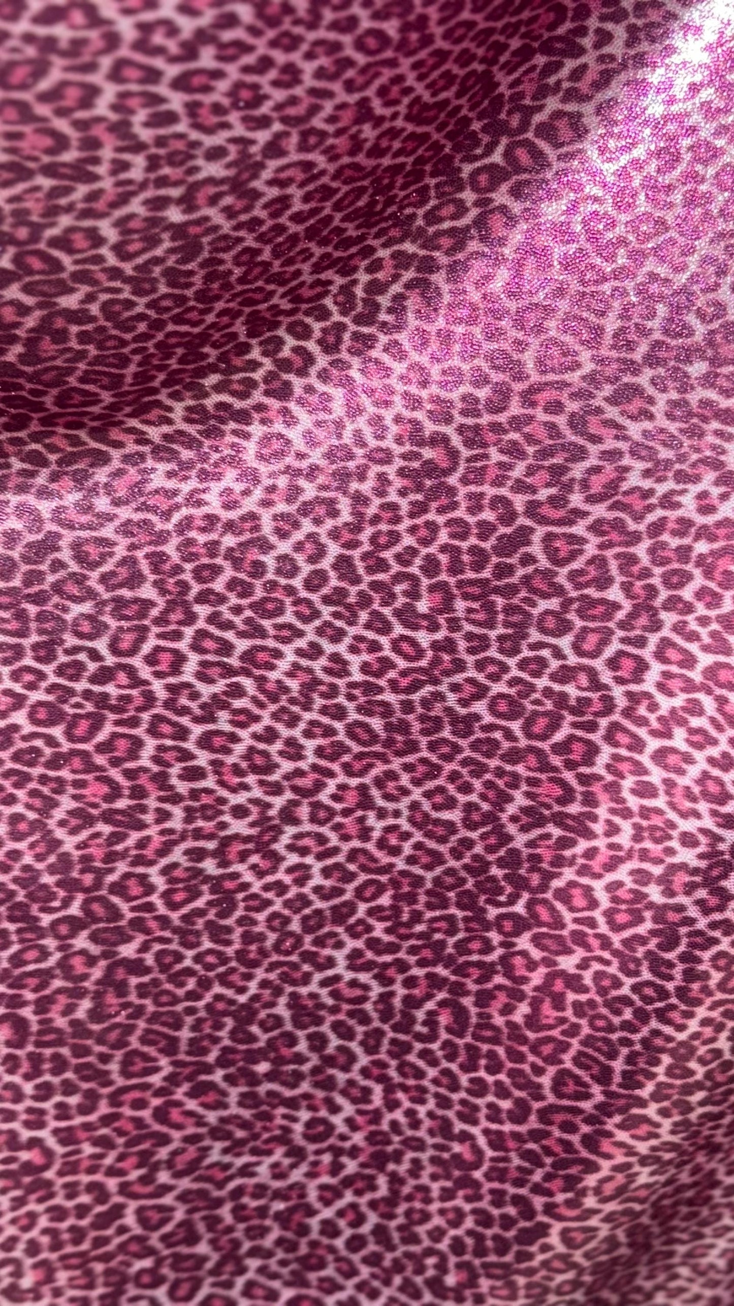 Wild Cheetah pink design Small size on foggy foil metallic nylon spandex 4-way stretch 58/60” Sold by the YD. Ships worldwide