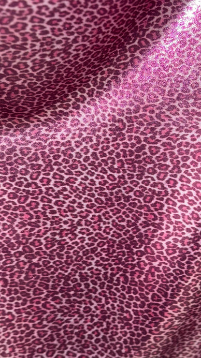 Wild Cheetah pink design Small size on foggy foil metallic nylon spandex 4-way stretch 58/60” Sold by the YD. Ships worldwide