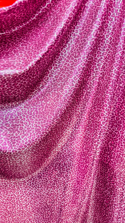 Wild Cheetah pink design Small size on foggy foil metallic nylon spandex 4-way stretch 58/60” Sold by the YD. Ships worldwide