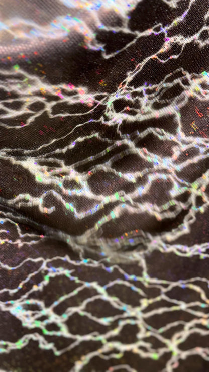 Thunderbolt design on Shattered Glass Hologram Metallic nylon spandex 4way Stretch 58/60" Sold by the YD Ships worldwide from Los Angeles CA