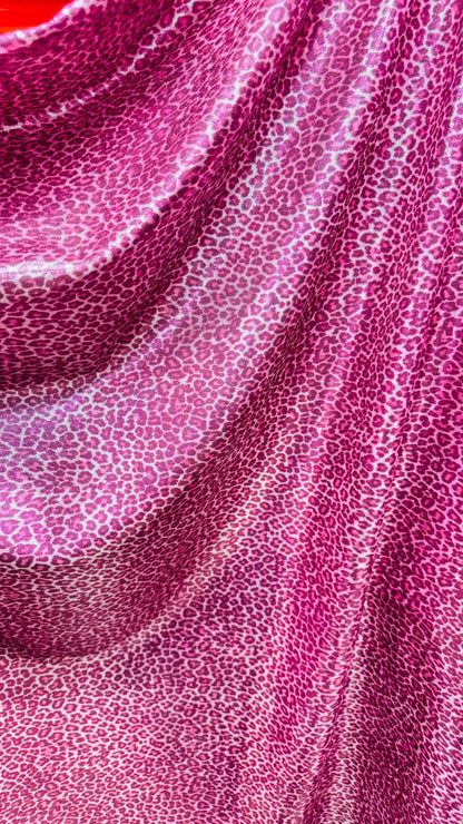 Wild Cheetah pink design Small size on foggy foil metallic nylon spandex 4-way stretch 58/60” Sold by the YD. Ships worldwide