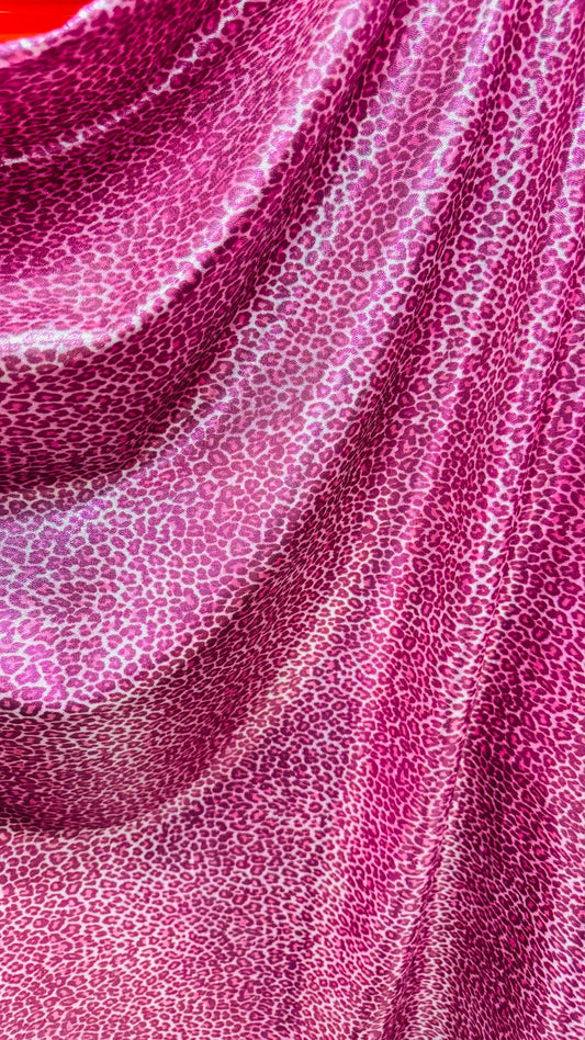 Wild Cheetah pink design Small size on foggy foil metallic nylon spandex 4-way stretch 58/60” Sold by the YD. Ships worldwide
