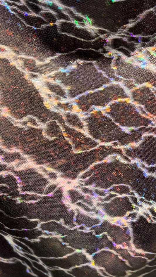 Thunderbolt design on Shattered Glass Hologram Metallic nylon spandex 4way Stretch 58/60" Sold by the YD Ships worldwide from Los Angeles CA