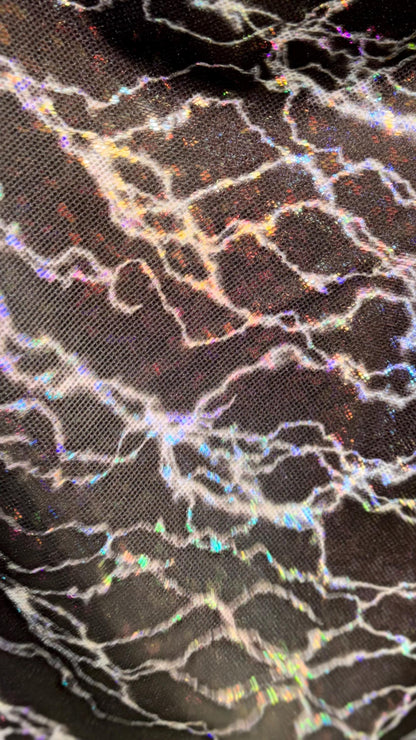 Thunderbolt design on Shattered Glass Hologram Metallic nylon spandex 4way Stretch 58/60" Sold by the YD Ships worldwide from Los Angeles CA