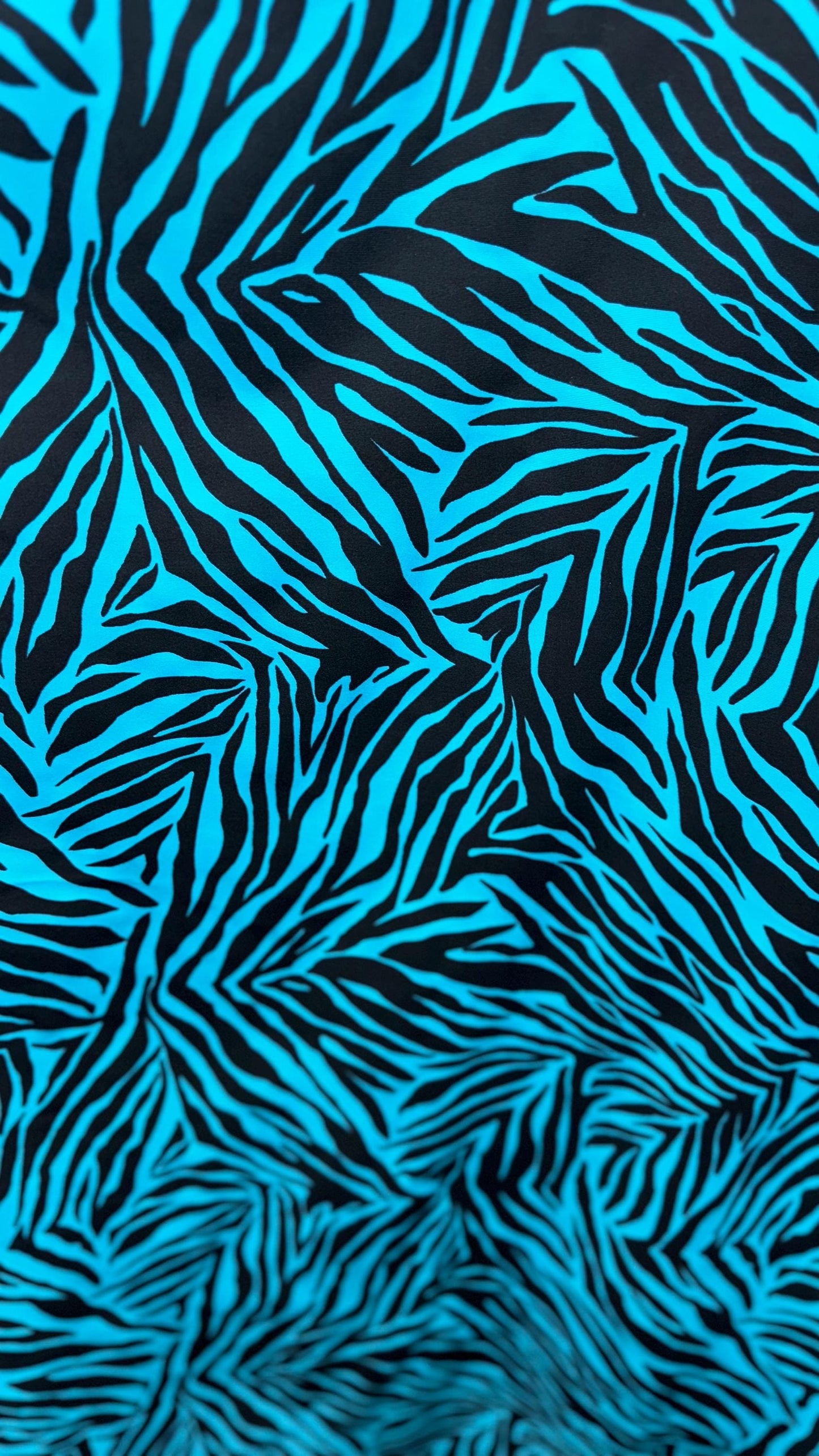 New zebra design turquois/Black print on nylon spandex 4way stretch 58/60" Sold by the YD. Ships worldwide from Los Angeles California USA.