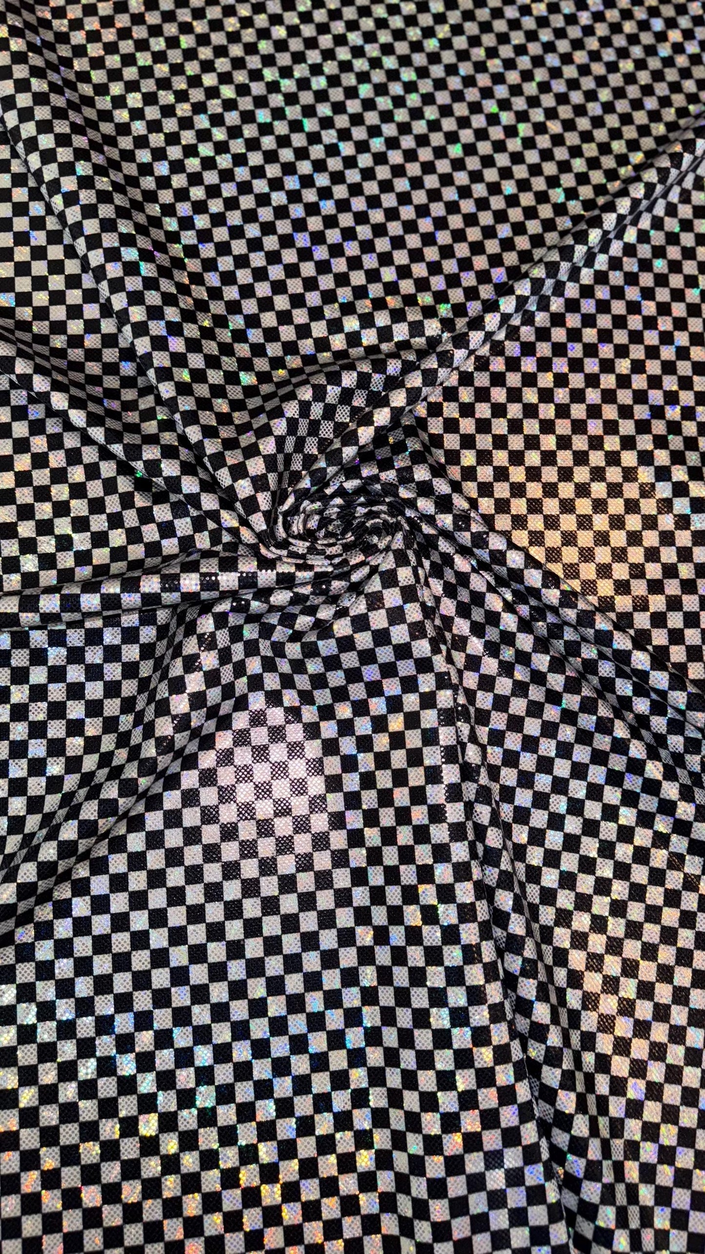 Checkers design Small size on shattered glass New metallic hologram nylon spandex 4-way stretch 58/60” Sold by the YD. Ships worldwide