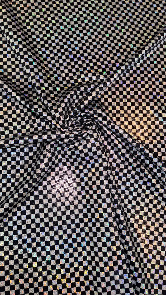Checkers design Small size on shattered glass New metallic hologram nylon spandex 4-way stretch 58/60” Sold by the YD. Ships worldwide